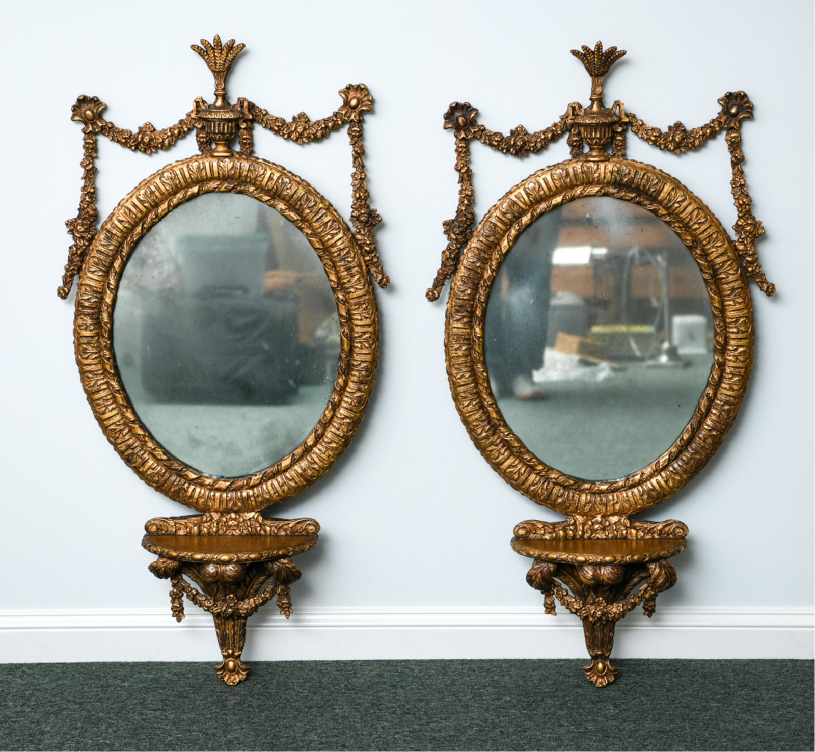 PAIR OF LOUIS XVI STYLE MIRRORS: Contemporary mirrors with faux gilded, antiqued surface. Faux aged glass. Dimensions: H 45" x W 23" Condition: Wear consistent with age and use.