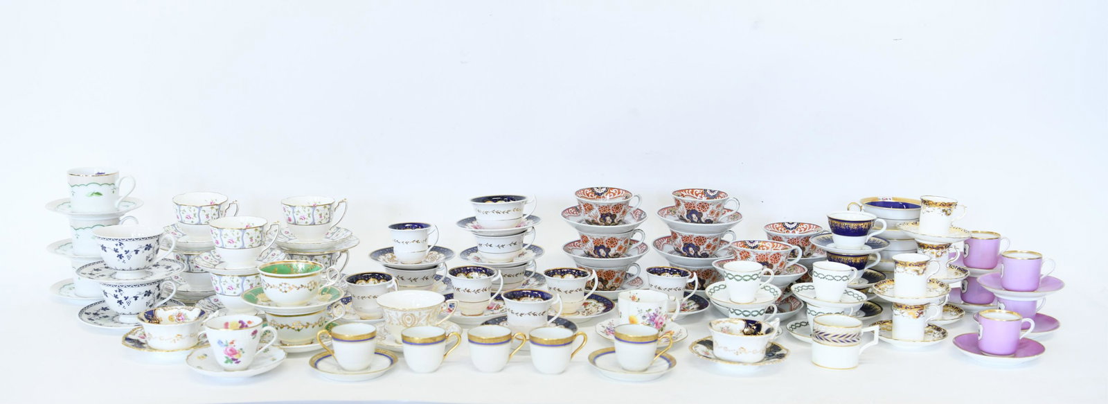 LARGE GROUPING OF PORCELAIN CUPS & SAUCERS: Including: Wedgwood, Mintons, Royal Crown Derby, etc. Dimensions: (Largest saucer) Dia. 6.25" Condition: Various damages including chips, cracks, hairlines, etc.