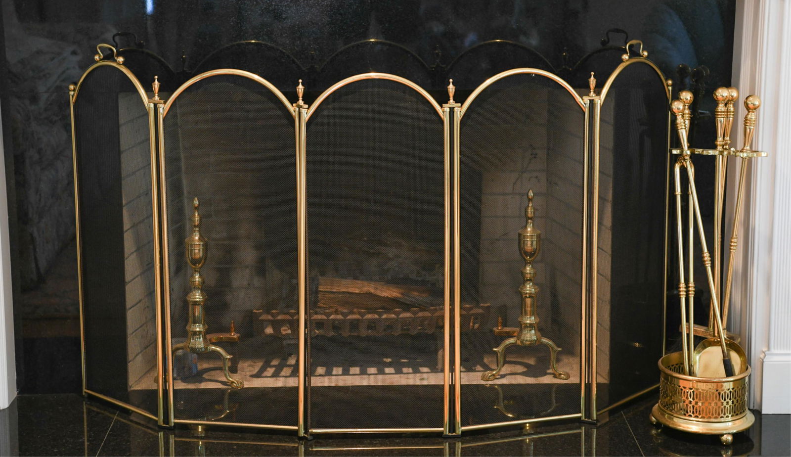 BRASS FIREPLACE SCREEN, ANDIRONS, & TOOLS: 13.5" segments of screen. Log holder and fireback not included. Dimensions: (Screen per segment) H 35.25" x W 13.5", (Fireplace tools) H 31.5", (Andirons) H 20" Condition: No issues to note.