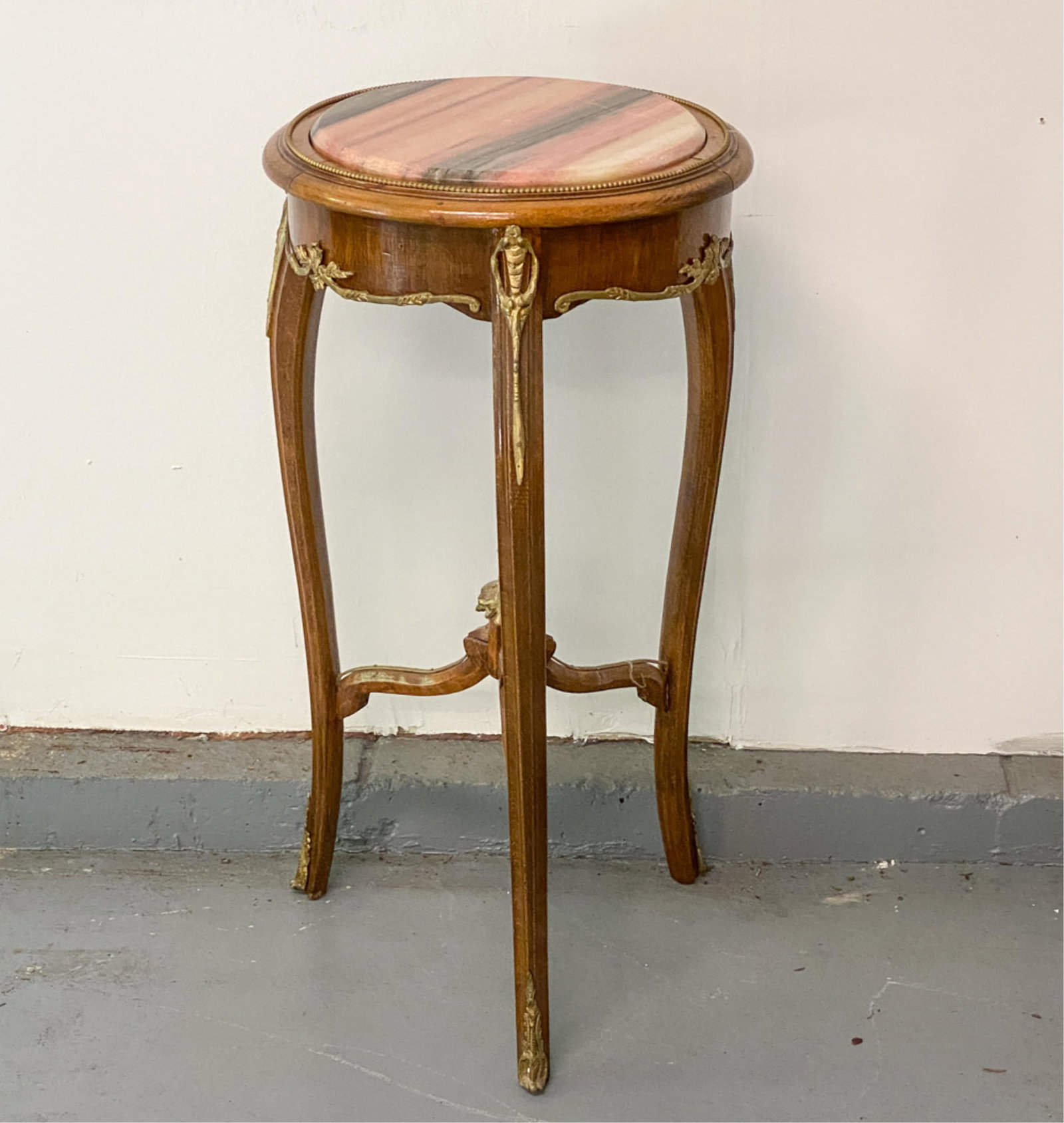 MARBLE TOP STAND: Ormolu mounts. Dimensions: H 29.75" x Dia. 16" Condition: Some joint separation. Light wear consistent with use.