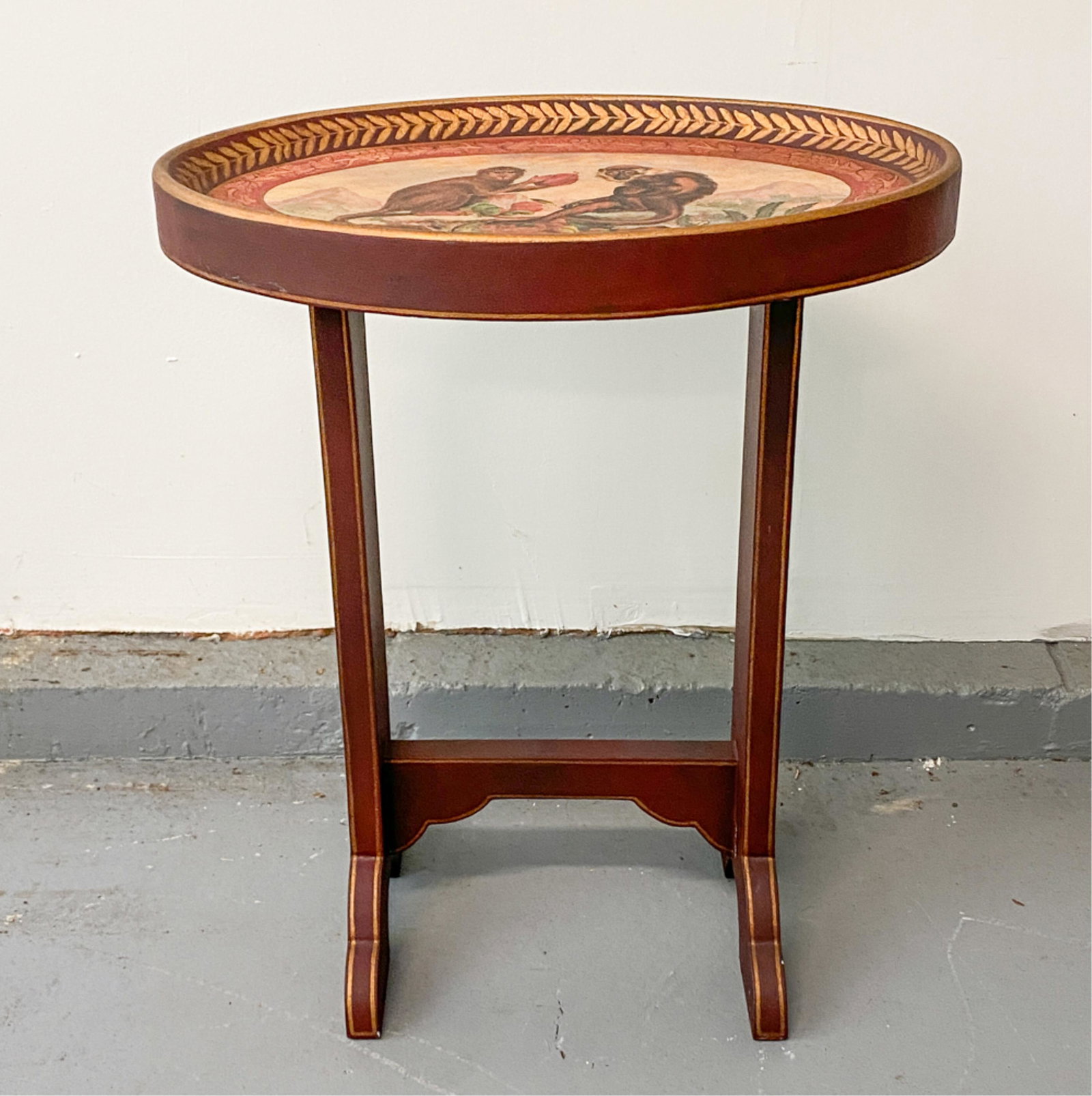 DECORATIVE MONKEY TRAY TOP SIDE TABLE: Applied print of monkeys to top. Dimensions: H 24" x W 20" x D 13" Condition: Few nicks to edges. Light wear from use.