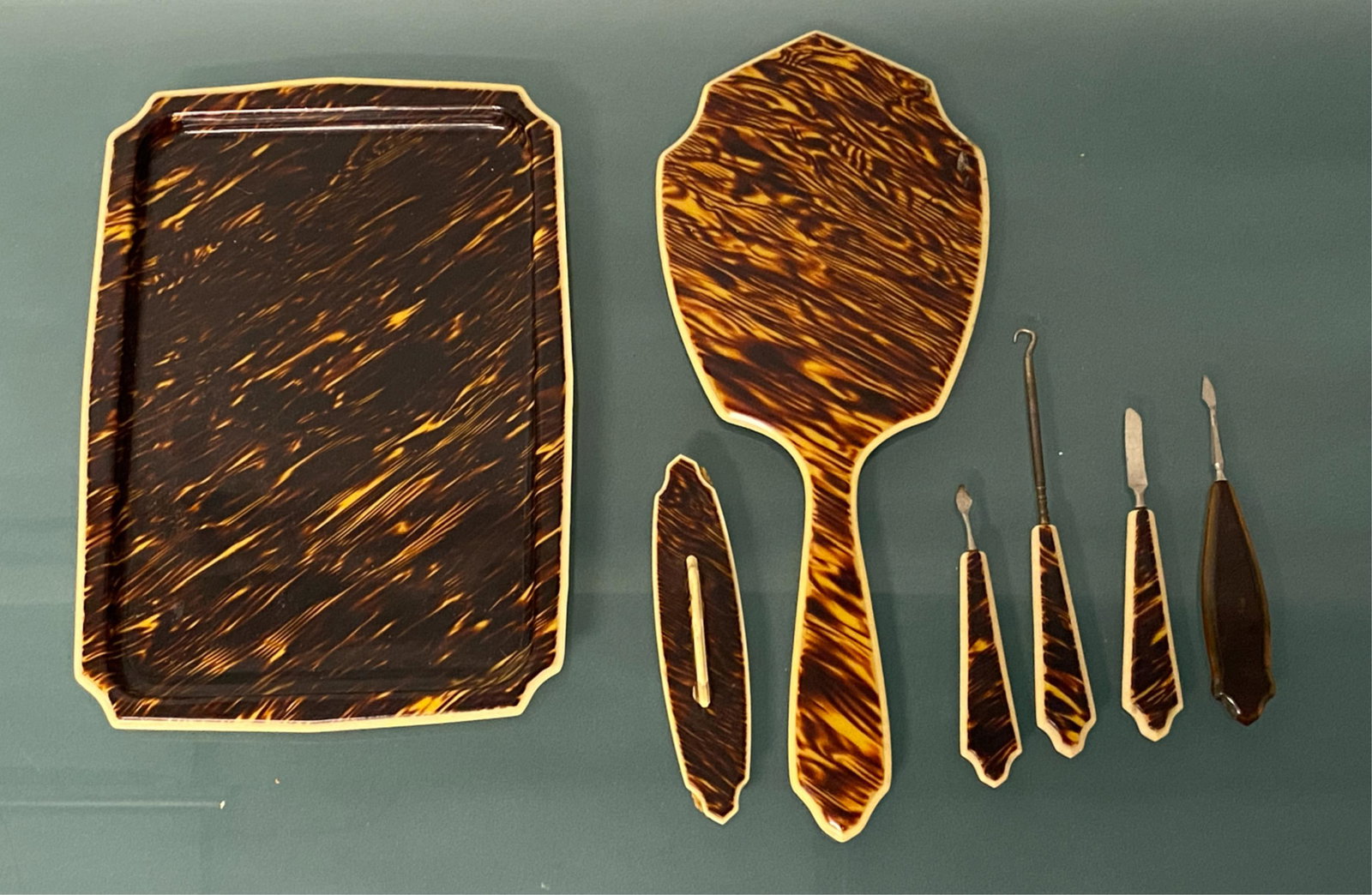 FAUX TORTOISE CELLULOID DRESSER SET: Dimensions: Tray: L 11" x W 8" Condition: Minor burn marks to mirror, light scratching, normal signs of use.