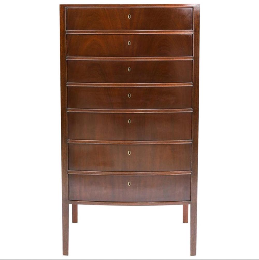 OLE WANSCHER FOR ILLUMS BOLIGHUS LINGERIE CHEST: A mahogany chest of drawers with a slightly curved front and seven drawers with individual locks. Designed by Ole Wanscher and manufactured for retailer Illums Bolighus, Denmark, circa 1957. Dimension