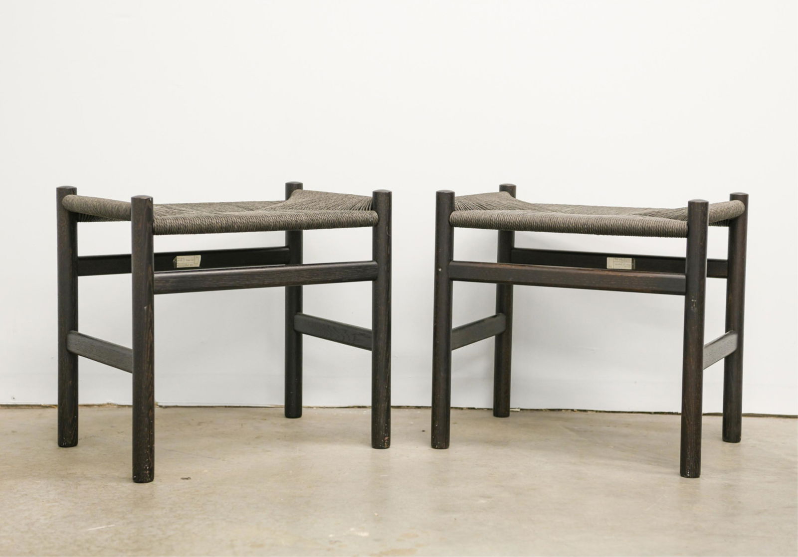 HANS WEGNER FOR CARL HANSEN CH53 FOOTSTOOLS: Black finish, rush seats. Dimensions: H 18.75" x W 19.5" x D 14.5" Condition: Few light marks.