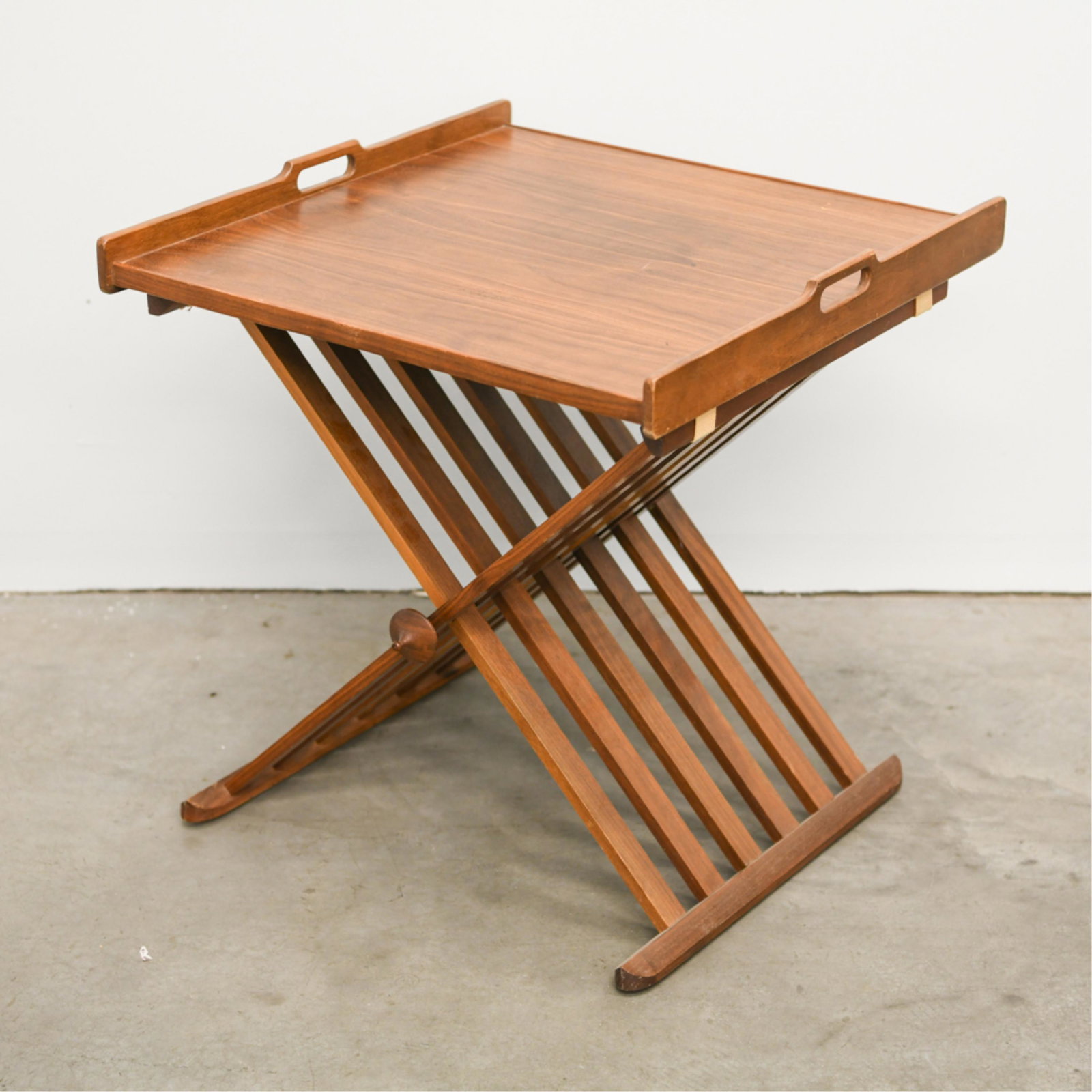 STEWART MACDOUGALL FOR DREXEL FOLDING TRAY TABLE: Marked Drexel underneath. Dimensions: H 21" x W 20" x D 21" Condition: Nicks and dings to edges. Surface scratches and scuffs. One base finial missing.