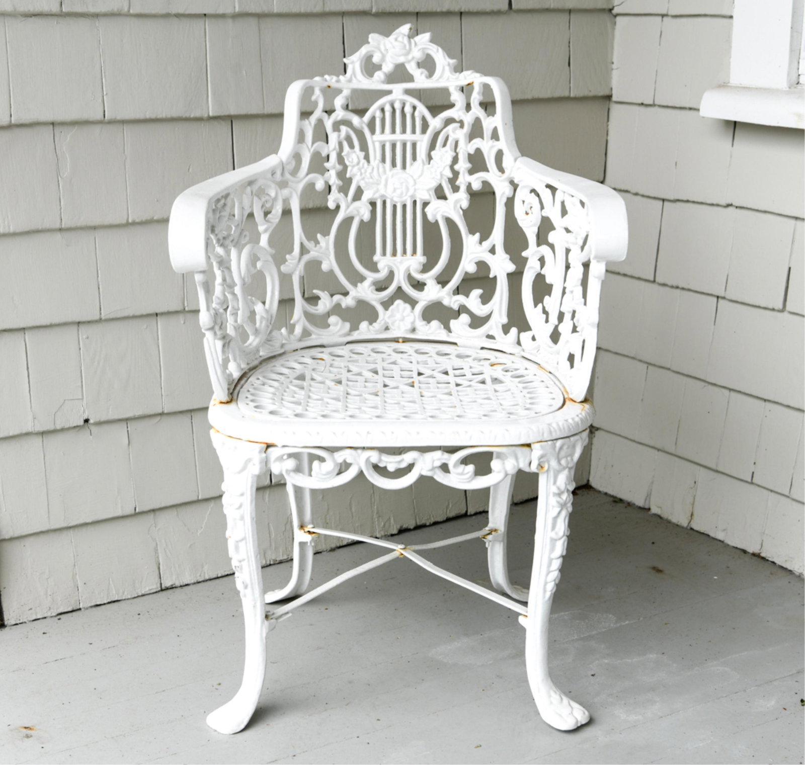 ANTIQUE CAST IRON BERGERE CHAIR: Dimensions: H 32.5" x W 21.25" x D 20" x SH 15" Condition: Some areas with visible rust. Crack where one armrest meets chair seat.