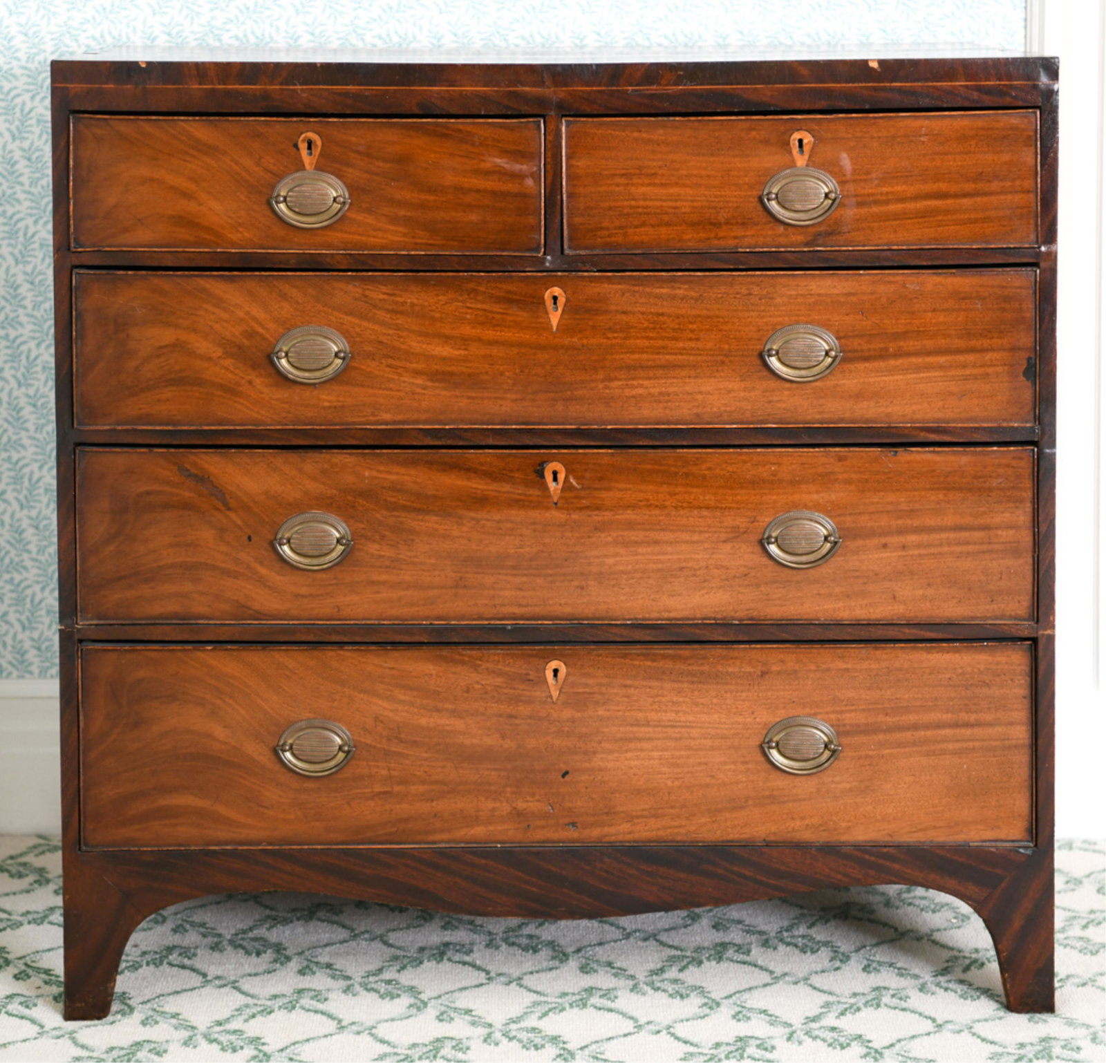HEPPLEWHITE CHEST OF DRAWERS: Inlaid escutcheons. Dimensions: H 39.75" x W 40" x D 19.25" Condition: Some water stains, small cracks, losses and old repairs to veneer. Nicks and dings to edges. Wear consistent with age and use.