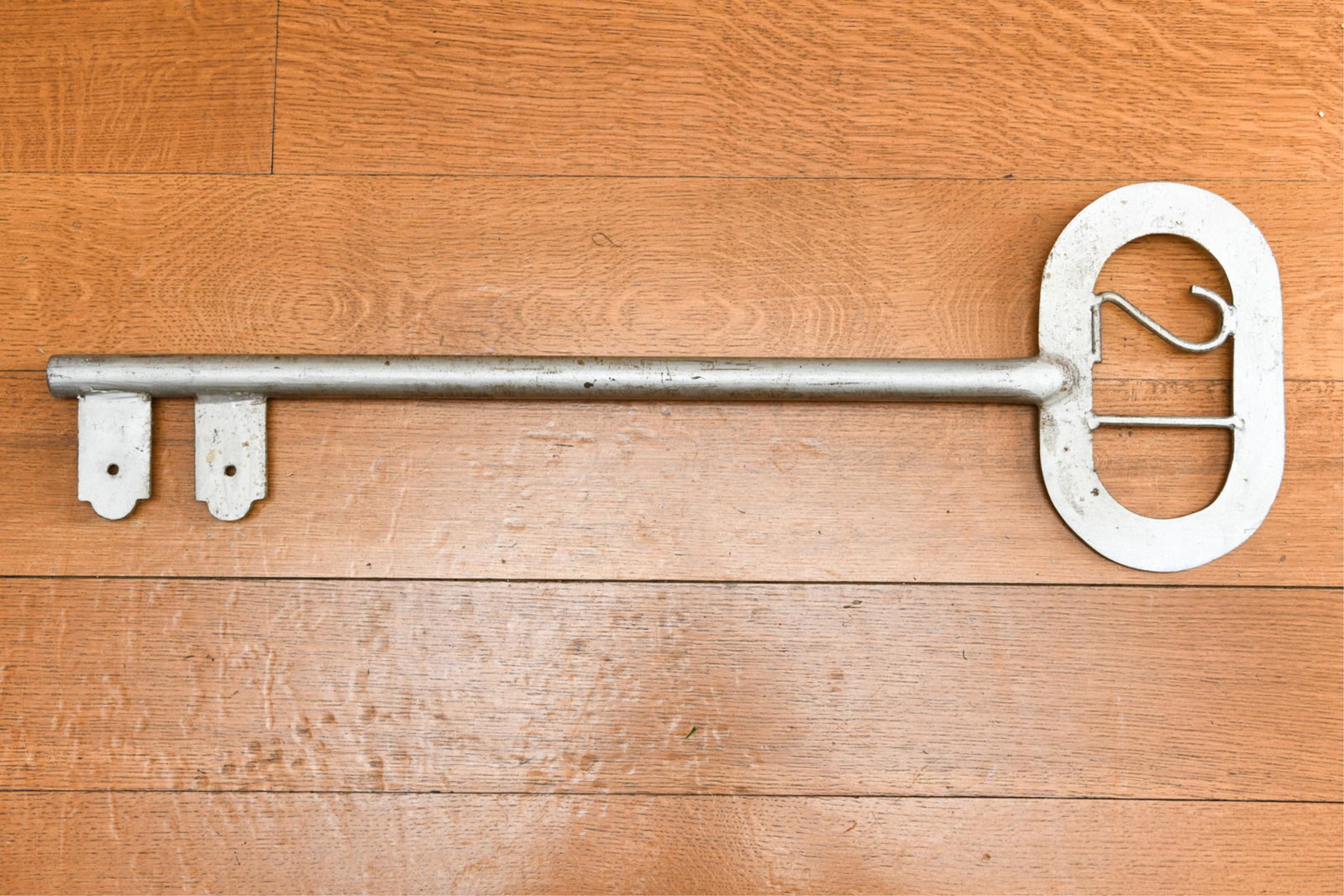 OVERSIZED KEY DECORATION: Painted metal. Dimensions: H 30" x W 9.5" Condition: Some rubbing and wear.