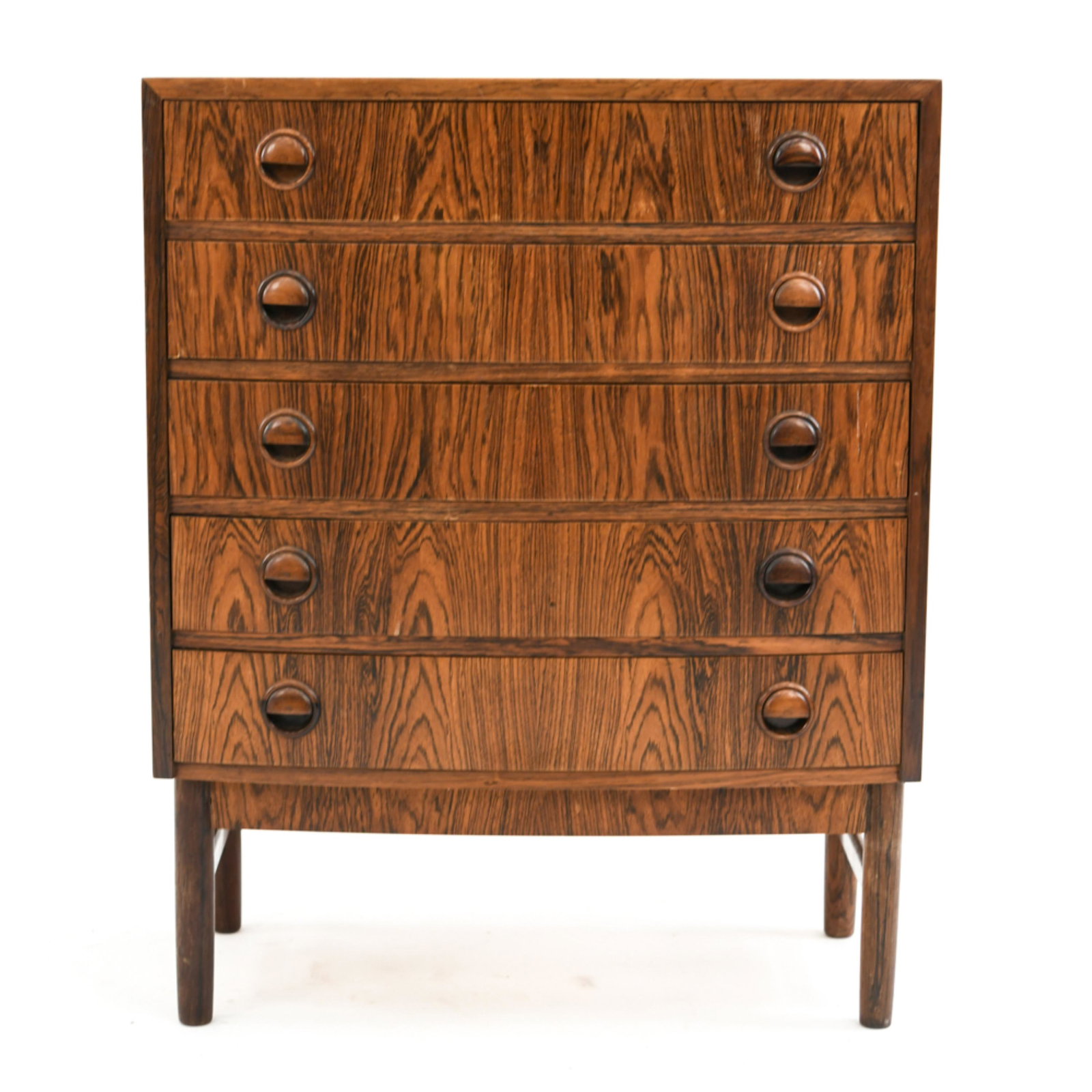 KAI KRISTIANSEN DANISH MID-CENTURY ROSEWOOD CHEST: This Danish mid-century rosewood chest of drawers was designed by the iconic name Kai Kristiansen. Featuring slightly bowed drawer fronts, solid sculpted drawer pulls, and rounded subtly tapered legs,