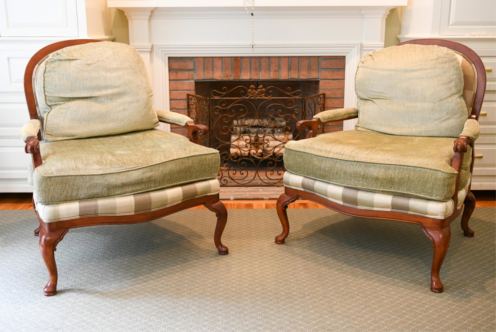 PAIR OF LOUNGE CHAIRS: Dimensions: H 39" x W 33" x D 30" Condition: Signs of use including small tears to piping, light spots of soiling. Some rubbing and scuffs to wood.