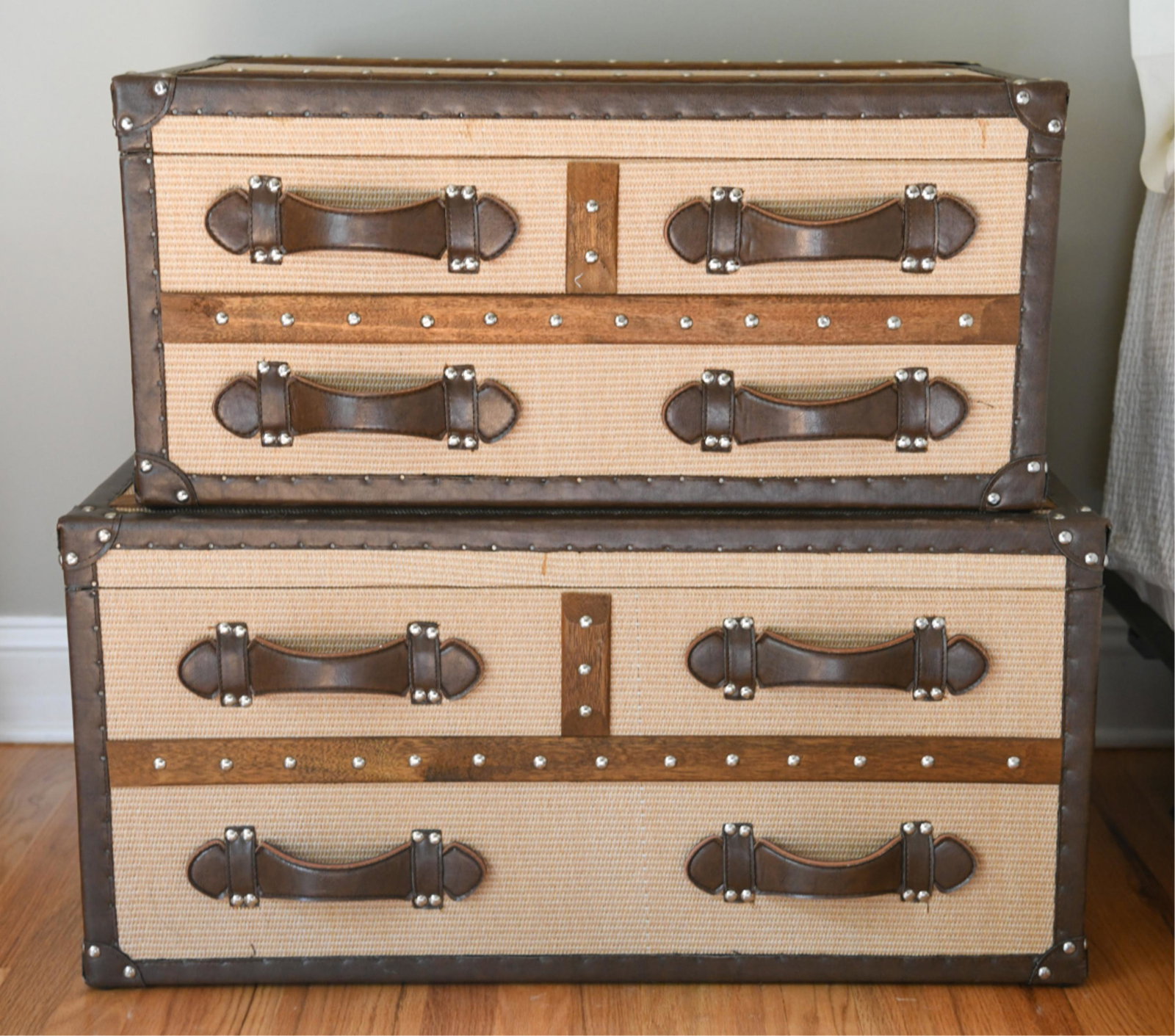 (2) WOVEN SURFACE W/ LEATHER CORNER TRUNKS: Dimensions: (Larger) H 15.5" x W 32" x D 19.25" Condition: Minor wear to corners.