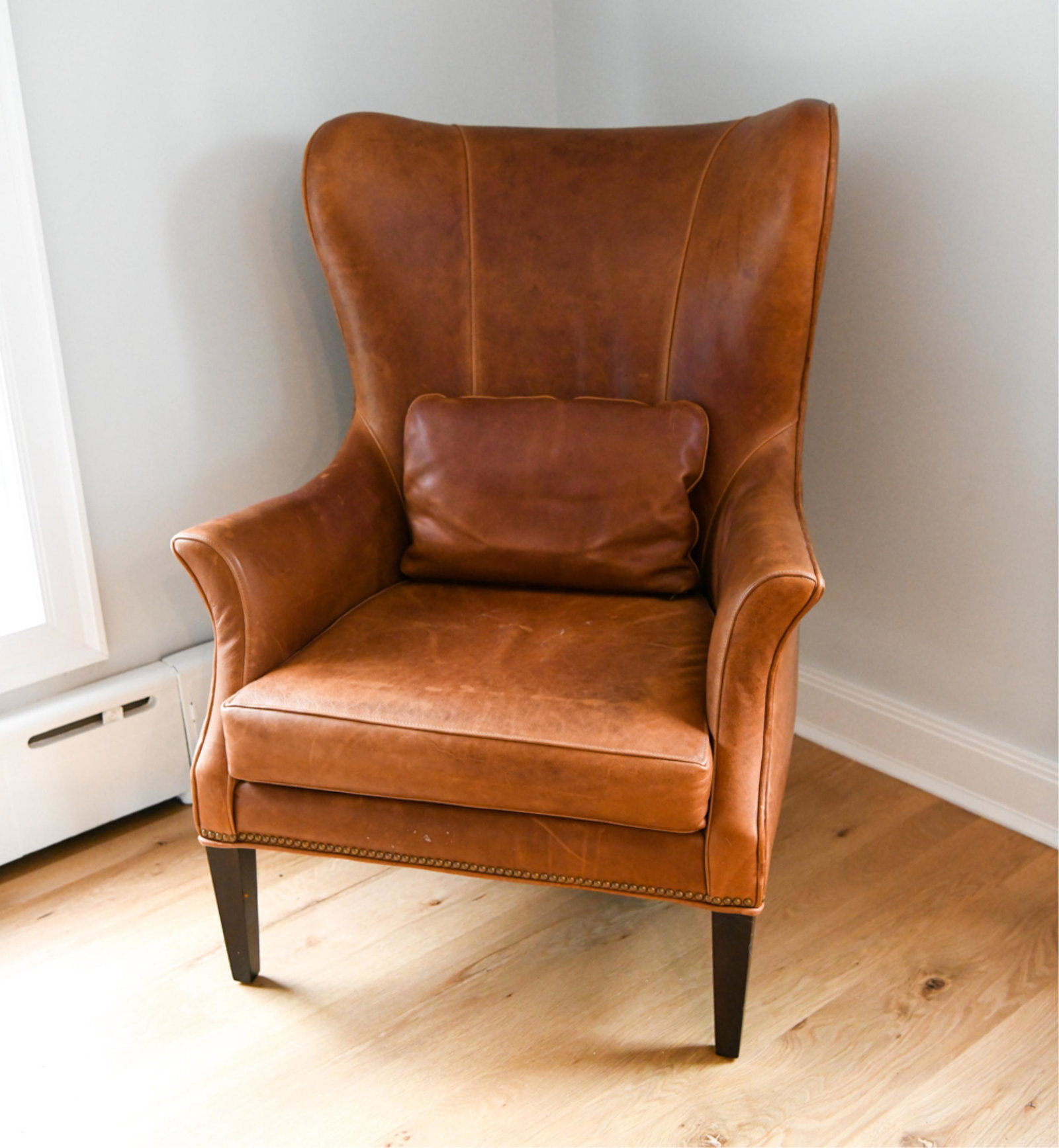LEATHER WINGBACK LOUNGE CHAIR: Dimensions: H 46" x W 34.5" x D 32" x SH 17.5" Condition: Handsome wear to leather including some scuffing and discoloration.