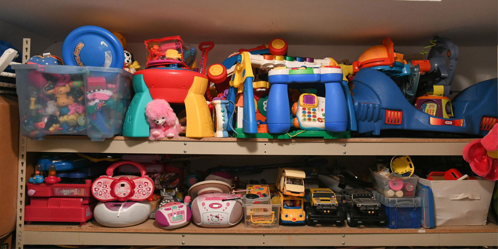 LARGE CHILDS TOY GROUPING: Including Little Tikes, Nikko cars, Hello Kitty boom box, Barbie radio, etc. Dimensions: (Largest) H 16.25" x W 36" x D 18.5" Condition: Used, showing normal signs of use.