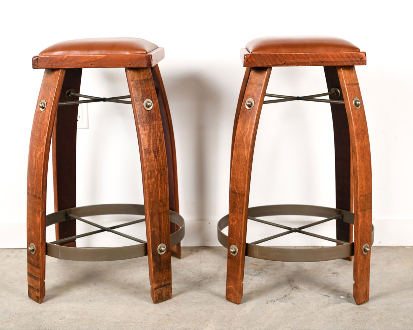 (2) WINE BARREL STOOLS: Modern stools made out of wine barrel staves Dimensions: H 29" x W 18.5" x D 18.5" Condition: Showing normal light signs of use. Few marks.