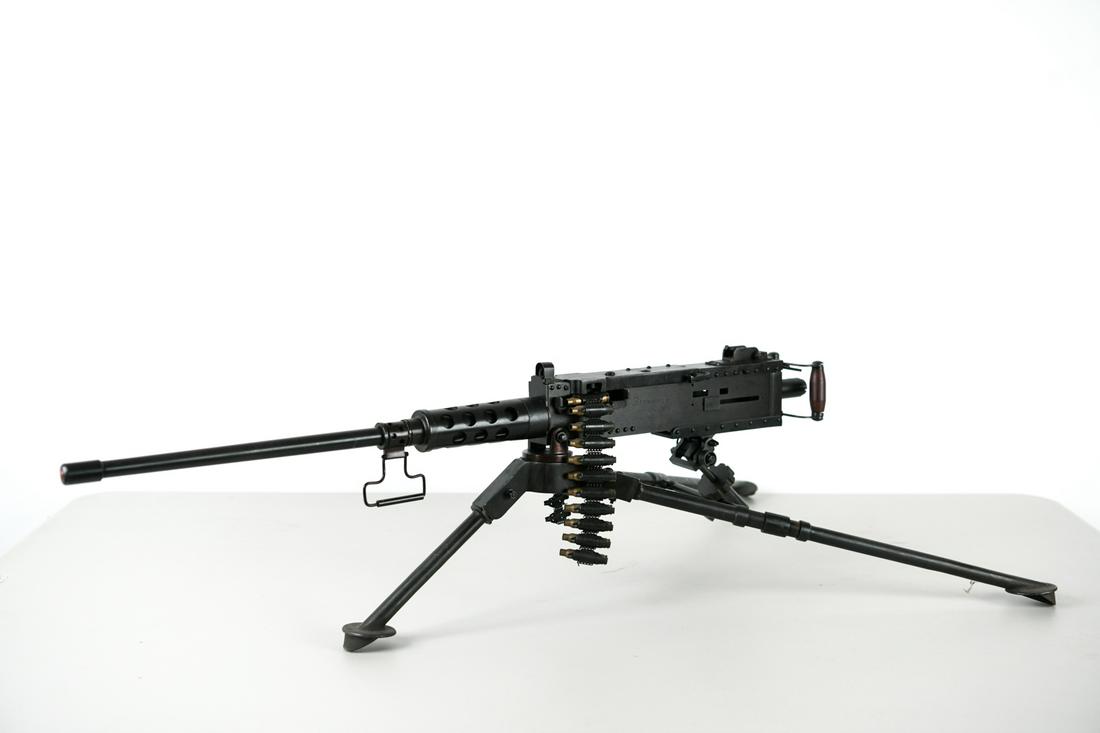 SCALE MODEL BROWNING .50 CALIBER MACHINE GUN: Miniature Browning 50 caliber. Dimensions: H 10" x W 35" x D 19.5" Condition: Light surface wear.