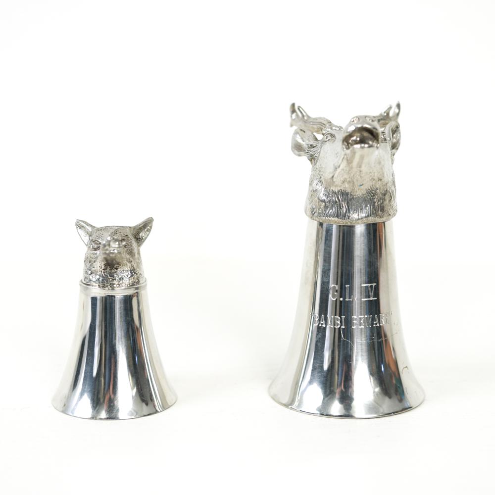 (2) PEWTER FOX AND STAG HEAD JIGGERS: One marked Comoy's, other with inscription. Dimensions: (Larger) H 5.5" x W 3" x D 3.5" Condition: Slight handling wear.