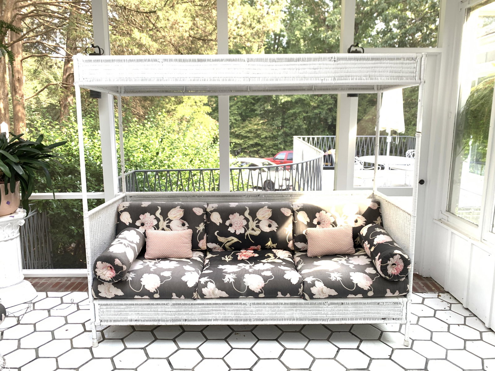 WICKER CANOPIED THREE SEAT SOFA: Dimensions: H 75" x W 84.5" x D 31.5" SH 19" Condition: Showing wear consistent with age and normal use. Some areas with paint loss and a few breaks. Sun fading to seat cushions. Seat good.
