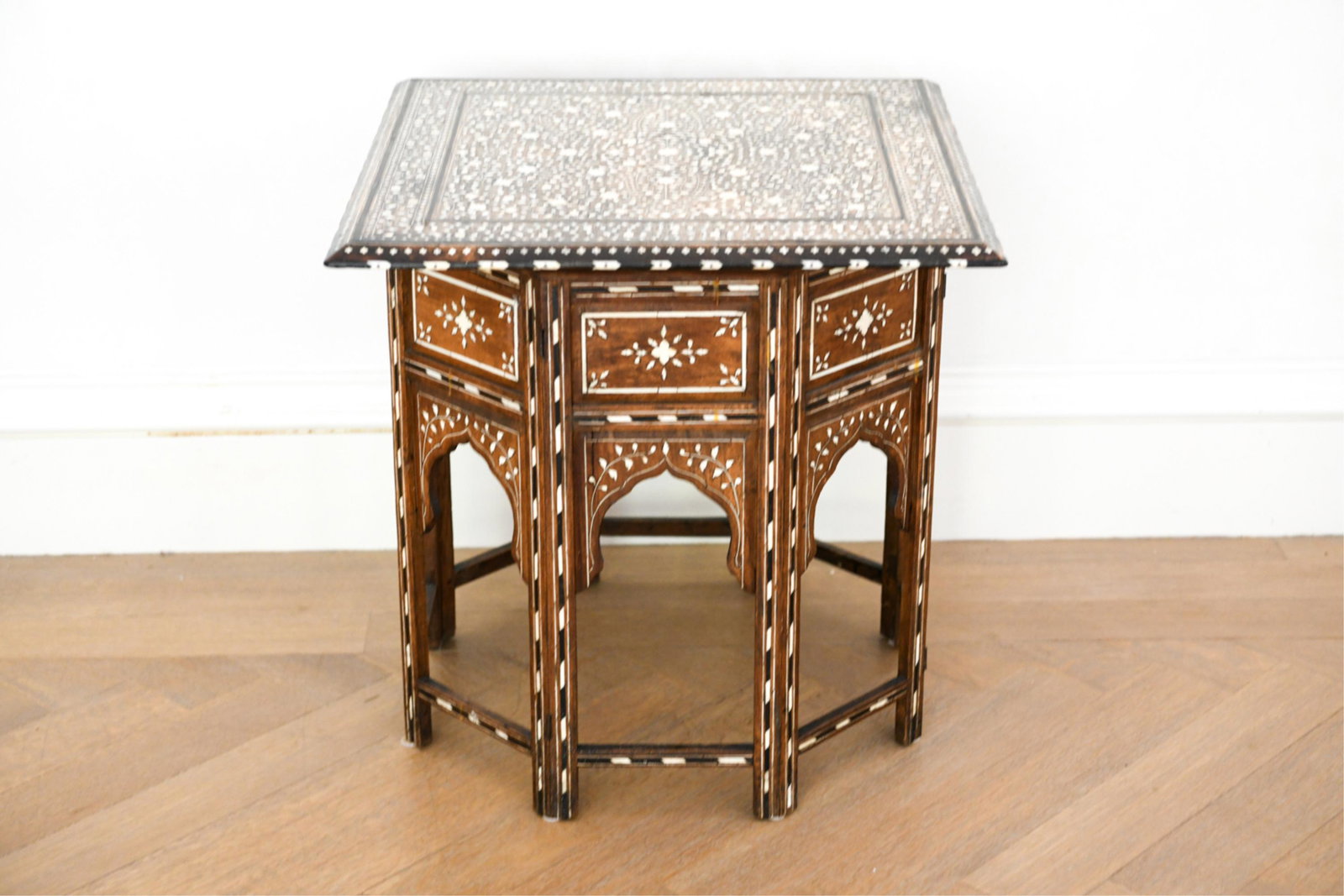 INLAID MOROCCAN SIDE TABLE: Dimensions: H 25.5" x W 24.5" x D 24.5" Condition: Some fills to missing inlay, some chips to edges. Sun fading to top. Some rubs to finish. Surface wear consistent with age and use. Some visible glue