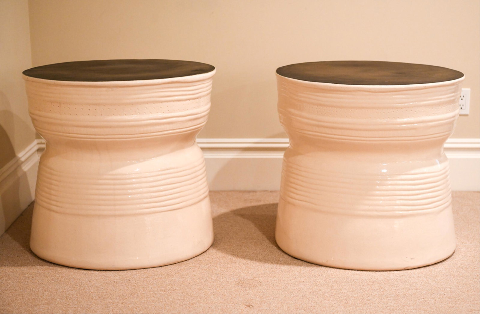 PAIR OF LARGE GLAZED CERAMIC SIDE TABLES: Off white glazed sides with a raku style finished top apparently unmarked Dimensions: H 24" x Dia. 28 " Condition: A few surface marks and chip to ones edge