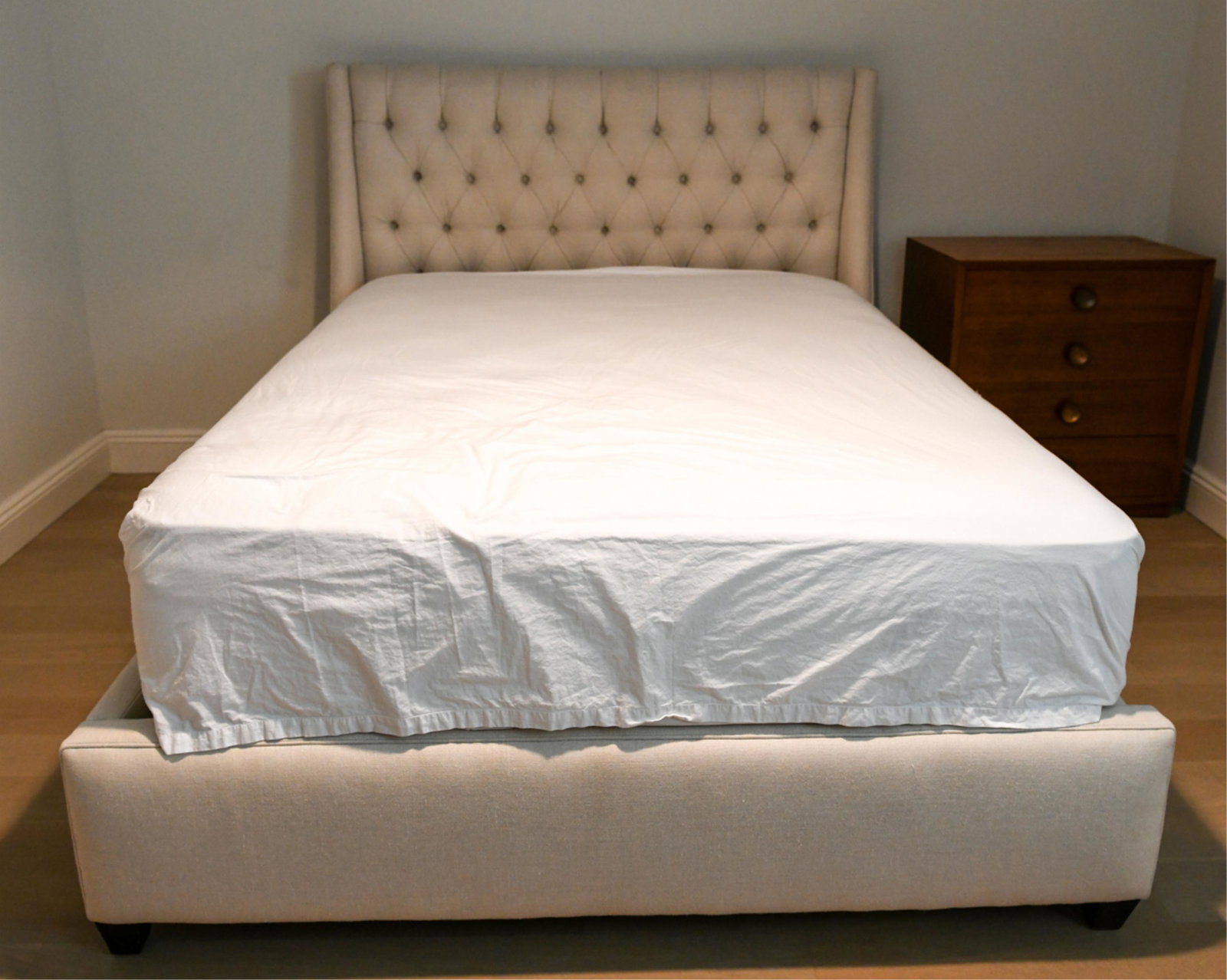 LILLIAN AUGUST TUFTED QUEEN BED: Dimensions: H 53.5" x W 66" x D 89.5" Condition: Showing light signs of use.