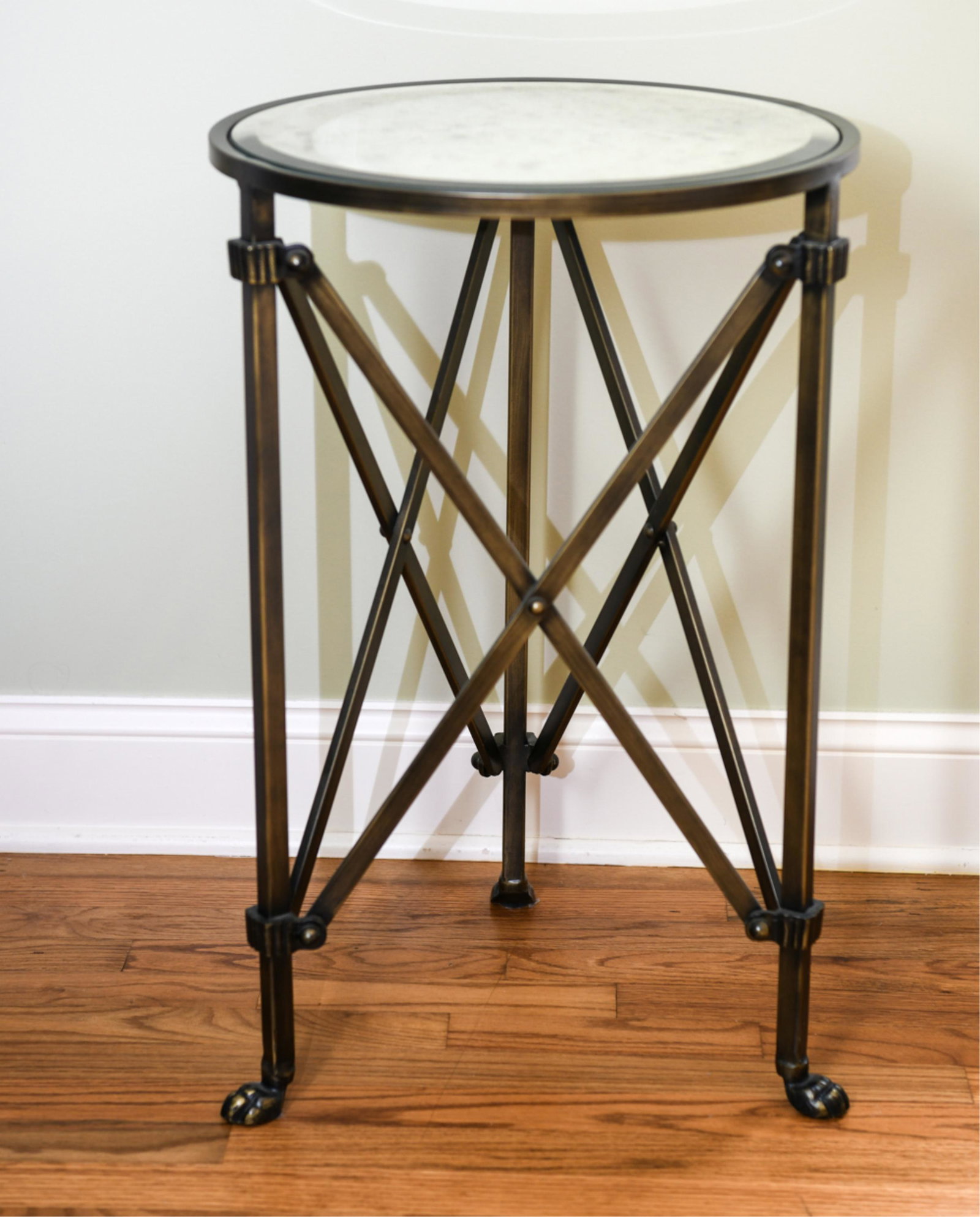 MIRRORED GLASS AND METAL SIDE TABLE: Dimensions: H 26.25” x Dia. 17.5” Condition: foxing and light scratches to mirror.