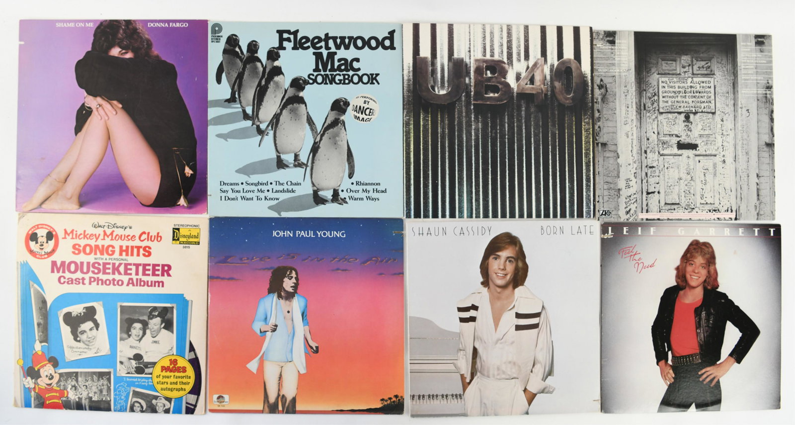 GROUPING OF VINTAGE RECORDS: Including Fleetwood Mac, Earth Wind & Fire, Dolly Parton, Bob Marley, Diana Ross, The Beach Boys, Elton John etc. Dimensions: (Pile) H 6" x W 12.5" x D 12.5" Condition: Untested. Wear consistent with