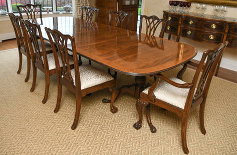 CHIPPENDALE STYLE DREXEL DINING TABLE & CHAIRS: One extra leaf included. Chairs and table marked on bottom Drexel Heritage furnishings. Claw and ball feet on table. Mahogany. (6) side chairs and (2) armchairs. Extensive carving throughout. Banded i