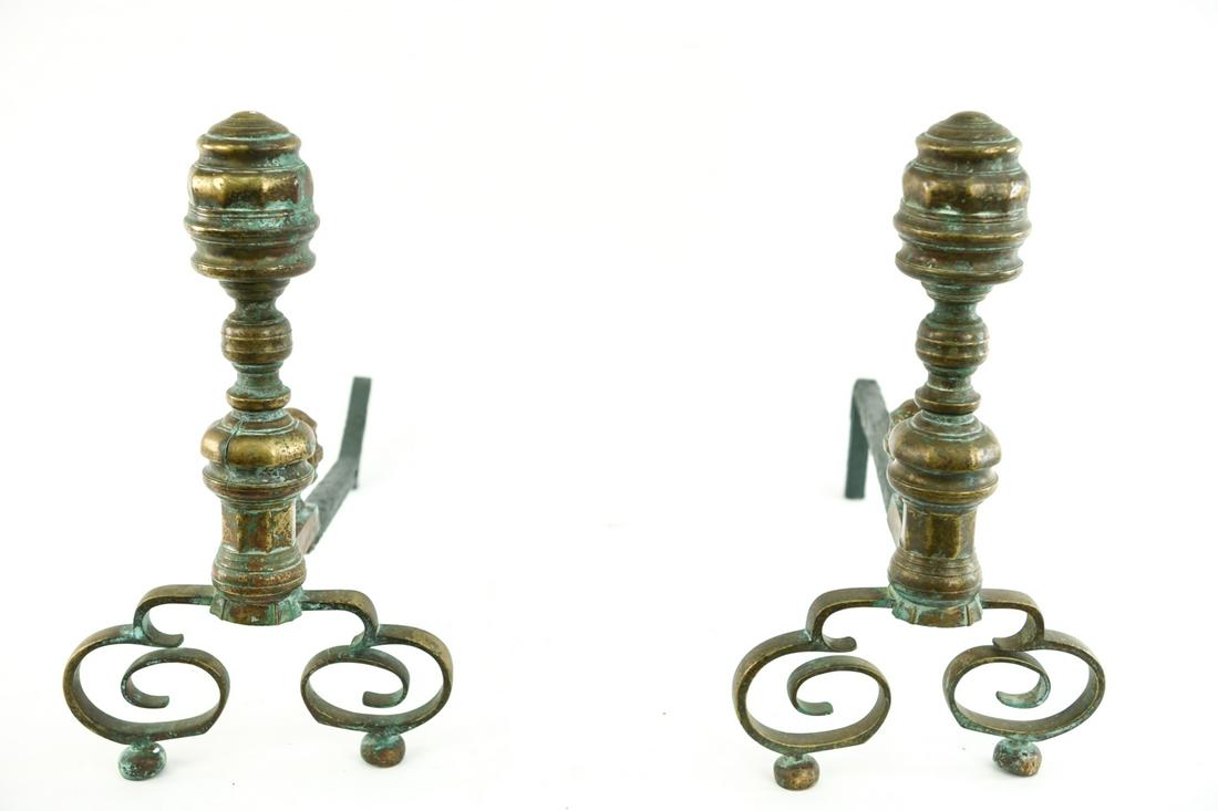 ANTIQUE BRASS ANDIRONS: Dimensions: H 18" x W 10.5" x D 22" Condition: Bent to one iron pole, some splitting to metal.