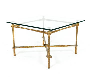 GIACOMETTI STYLE COFFEE TABLE: Wrought and gilt iron with glass top. Unsigned Dimensions: H 17" x W 24" x D 24.5" Glass (Dia.) 26" Condition: Base has worn patina. Glass has been replaced. Good overall condition.