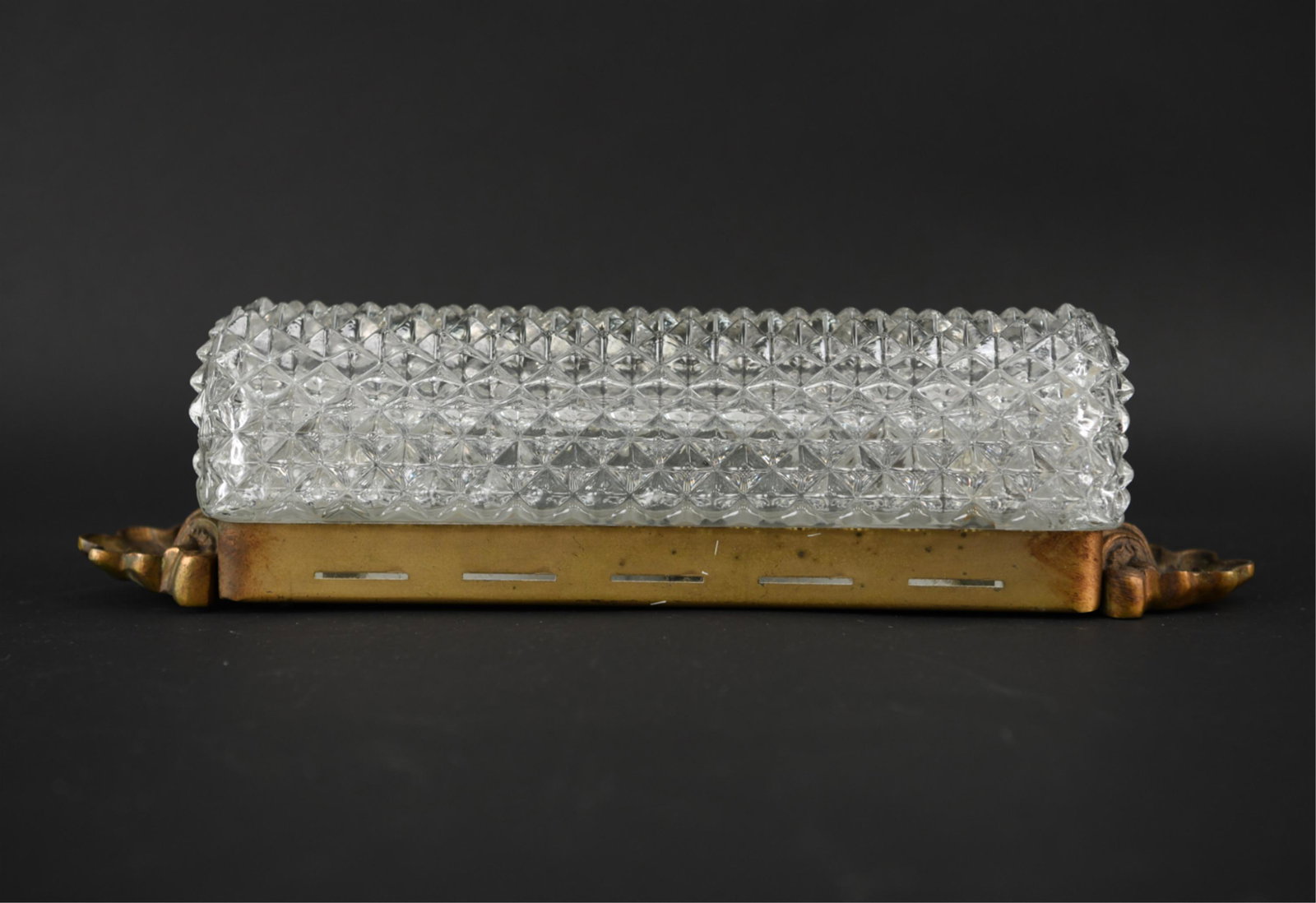 GLASS AND BRASS SCONCE: Dimensions: H 16" x W 4" x D 3.5" Condition: Sticker affixed to back, light scratching to brass.