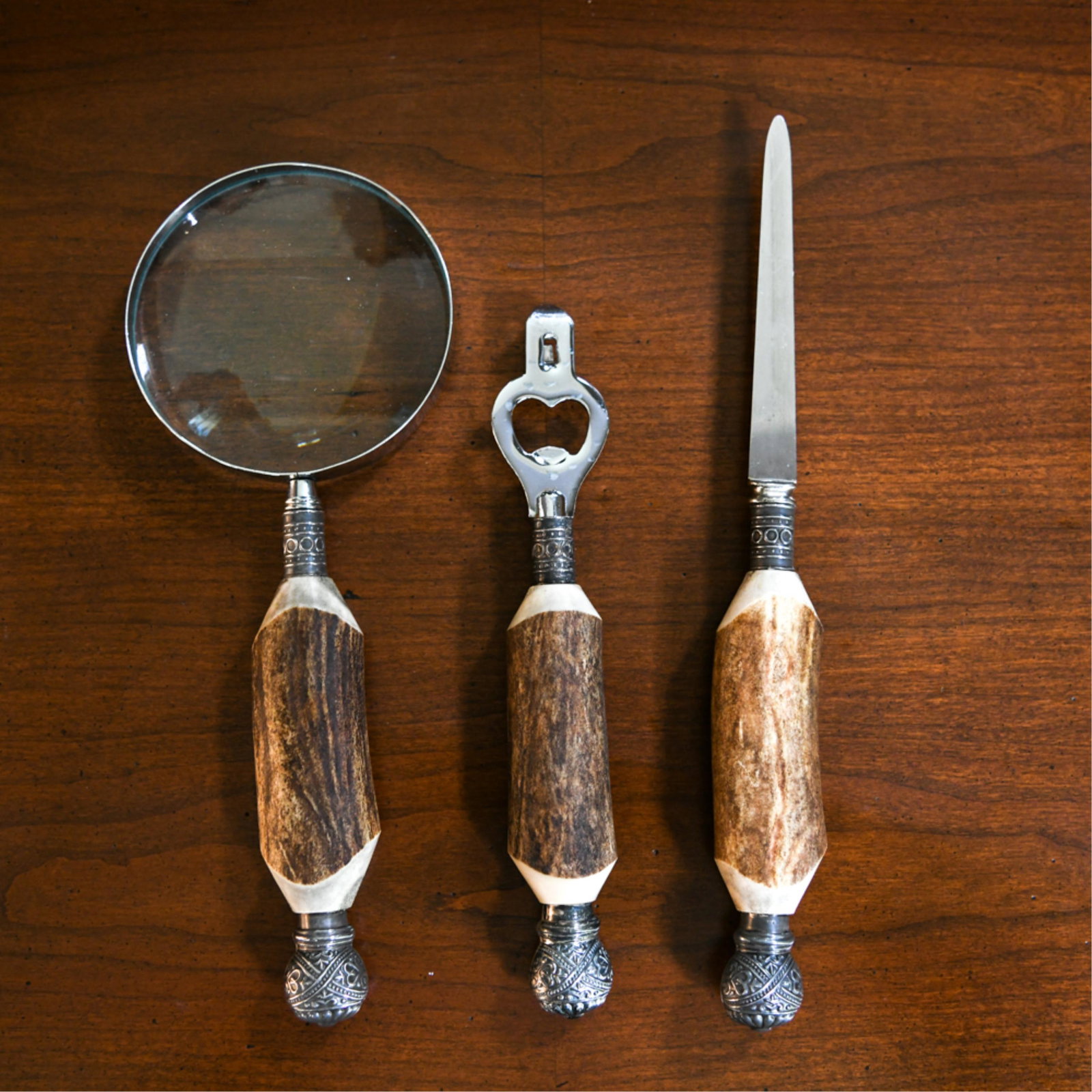 SHEFFIELD TOOL GROUPING: Including magnifying glass, can/bottle opener, and letter opener. Dimensions: (Magnifying glass) L 10.5" x W 4" Condition: Very light signs of use.