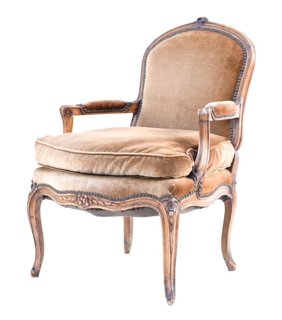 FRENCH LOUIS XV STYLE CARVED ARMCHAIR: With nailhead trim. Dimensions: H 35.5" x W 25" x D 31" x SH 19.5" Condition: Wear consistent with age and use including staining and fading to upholstery with scuffs, nicks and small losses to wood f