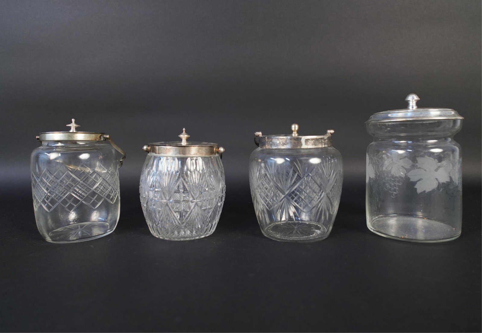 (4) CUT & ETCHED BISCUIT JARS ETC.: Silverplate tops. Dimensions: (Tallest) H 8" x Dia. 5" Condition: Tops may not be correct. Minor scratches and edge chips.