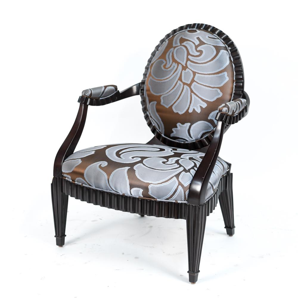 DONGHIA GRAND FLUTE ARM CHAIR: Graphic botanical inspired upholstery in sophisticated blue colorway, with a dark walnut frame. Marked underneath. Dimensions: H 37" x W 28.5" x D 30" SH 16" Condition: Chip to front leg. Light scuffs