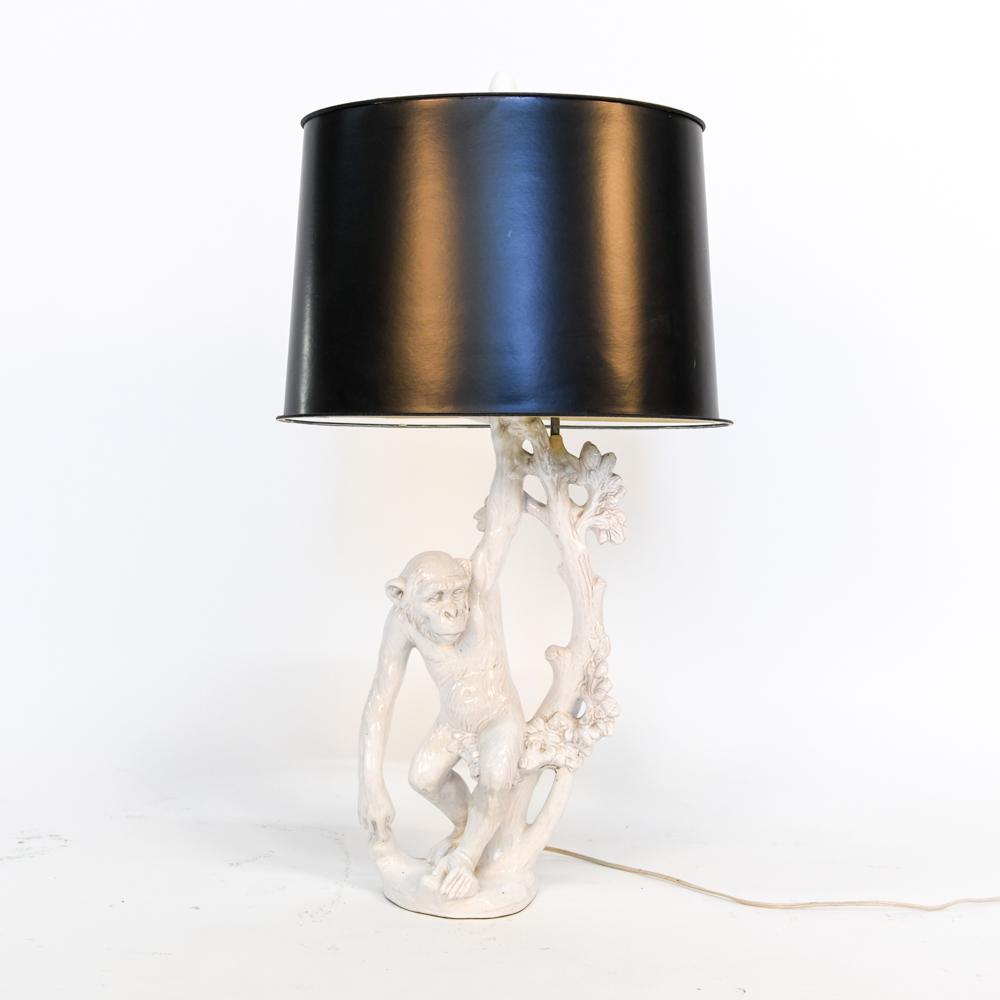 PORCELAIN MONKEY LAMP: Dimensions: (Incl. shade) H 33" x W 16" x D 10.75" Condition: Shade trim coming off. Repair where top of monkey figurine meets lamp pole. Some surface imperfections to porcelain.
