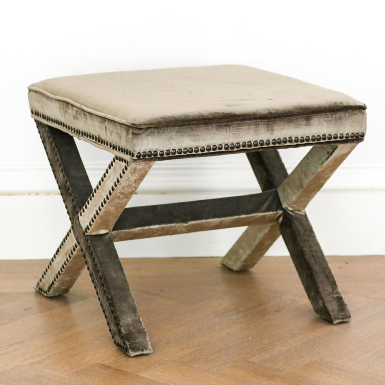 SAFAVIEH CONTEMPORARY X-BASE STOOL: With tacked upholstery. Marked underneath: Safavieh. Dimensions: H 19" x W 22.25" x D 21.75" Condition: Paint marks and stains to upholstery.