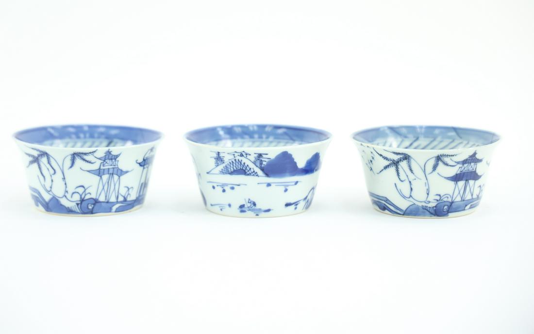(3) CHINESE BLUE AND WHITE PORCELAIN CUPS: Unsigned. Dimensions: (Each) H 2" x D 3.75" Condition: Couple flea bites to edge of one cup.
