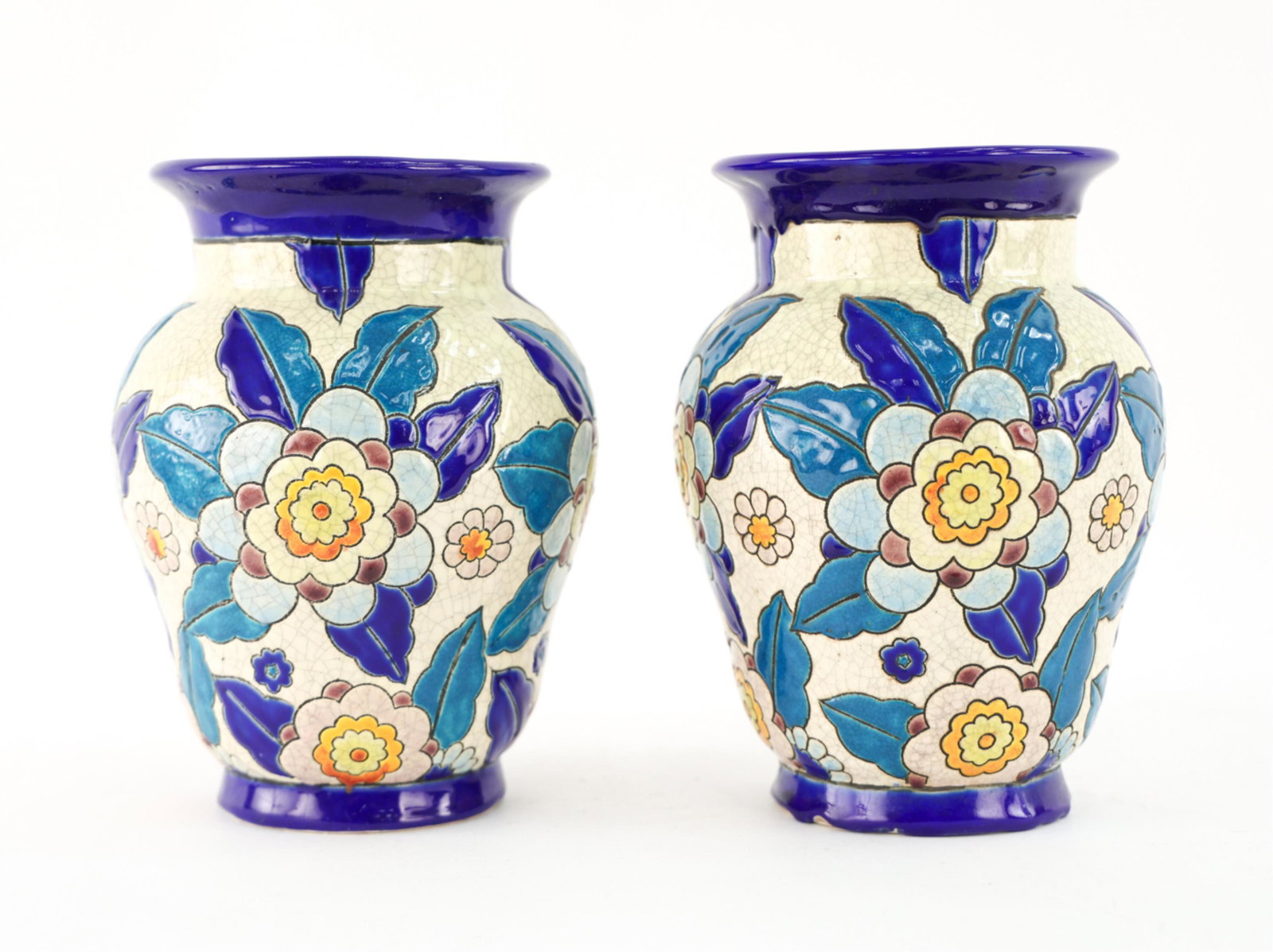 PAIR OF KERAMIS BELGIAN CERAMIC VASES: Marked Keramis underneath. Floral pattern. Dimensions: H 9" x Dia. 6.5" Condition: Some small chips. Few glaze imperfections. Crazing.