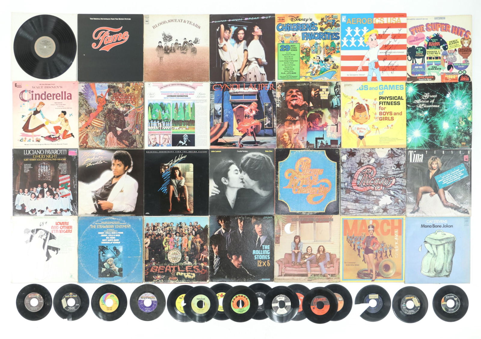 GROUPING OF RECORDS: A variety of vintage records, most in good playable condition, including Walt Disney's Cinderella, Luciano Pavarotti, Fame soundtrack, Michael Jackson, Tina Turner, The Beatles, and more. Dimensions: