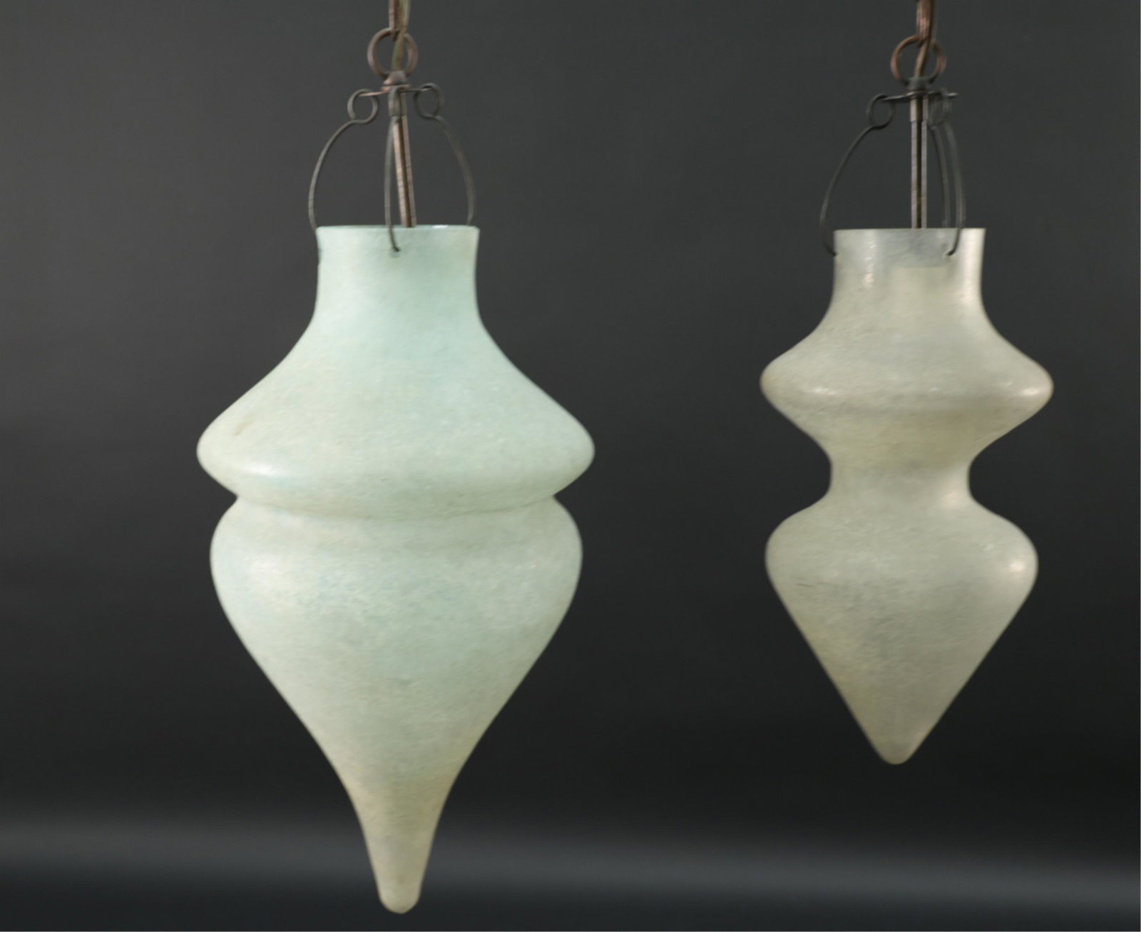 PAIR OF VETRI SOFIATTI MURANO CX DESIGN PENDANTS: Vintage. Italian art glass pendant lights. Iridescent sheen. Dimensions: (Larger) H 20.5" x Dia. 8" Condition: Green with 1" scallop chip along rim. Minor scuffs. Dirty.