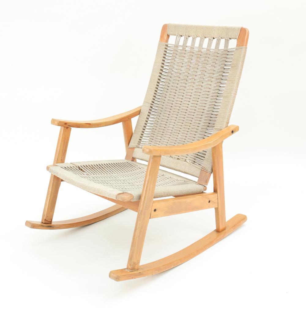 HANS WEGNER STYLE ROCKING CHAIR: Unmarked. Woven rope and wood. Dimensions: H 36" x W 25.25" x D 33" x SH 15" Condition: Rubbing, surface losses. Wobbly.