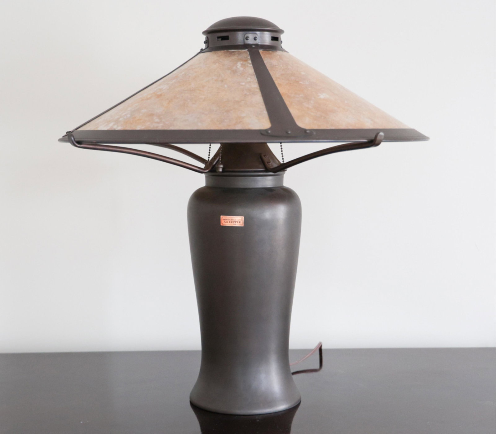 ARTS & CRAFTS STYLE ALL COPPER TABLE LAMP: With label: "American Design c. 1910, all copper, made in USA." Faux mica shade. Dimensions: H 26" x Dia. 24" Condition: Minor wear consistent with use. Note: This item must be picked up onsite from t