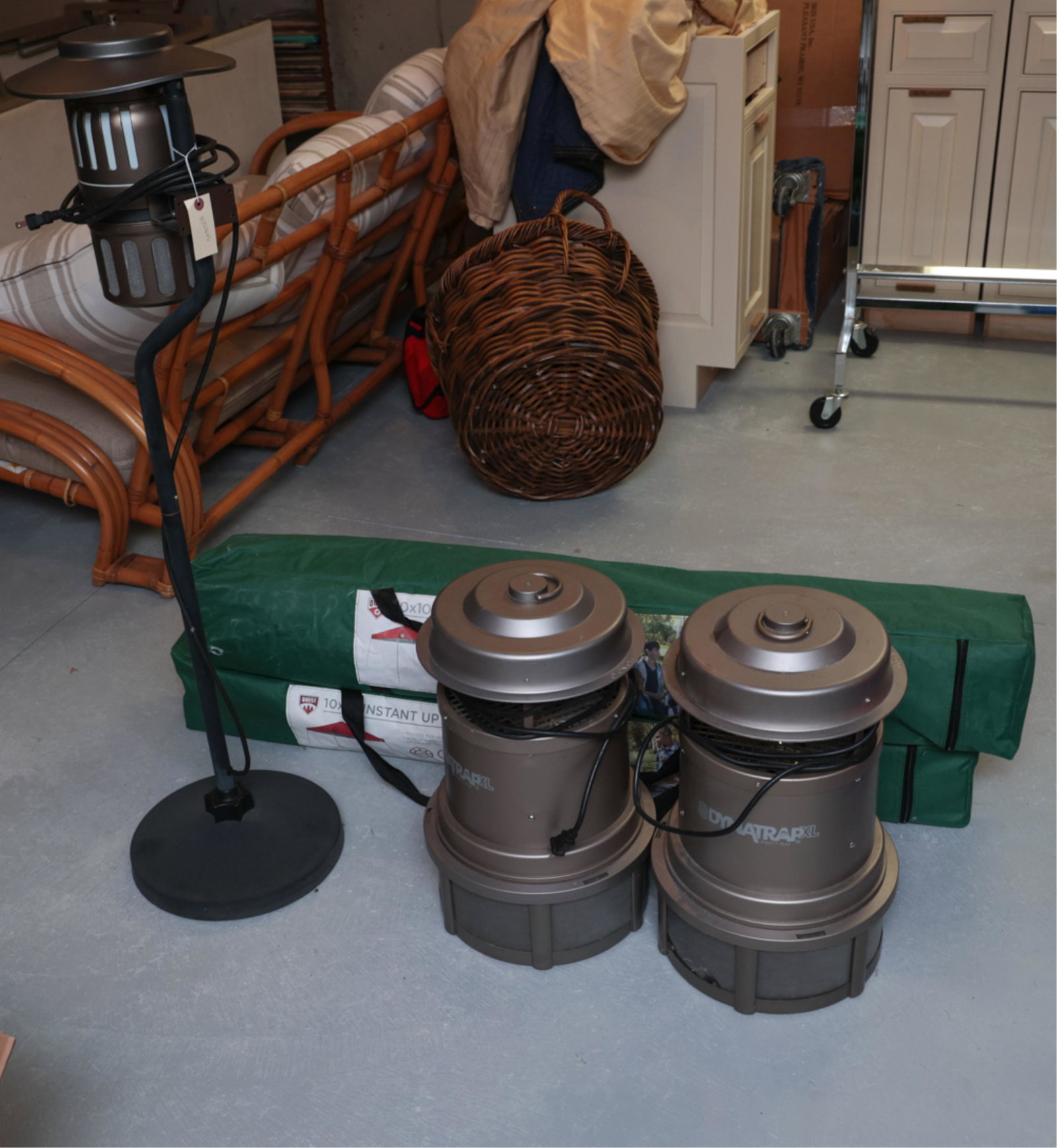GROUPING OF CAMPING EQUIPMENT INCL. TENTS: Including (2) Dynatrap XL insect trap, tall insect trap, two 10' x 10' instant pop -up canopies, one hard arm folding chair. Dimensions: (Tall insect trap) H 48" x Dia. 13" Condition: Showing light si