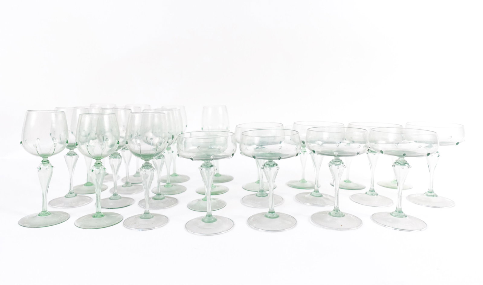 (29) GREEN GLASS STEMWARE GROUPING: Including (13) Wine glasses, (8) medium chalices and (8) large chalices. Dimensions: (Wine glass) H 7.5" x Dia. 3.25" Condition: Wear consistent with age and use including some light surface scratches