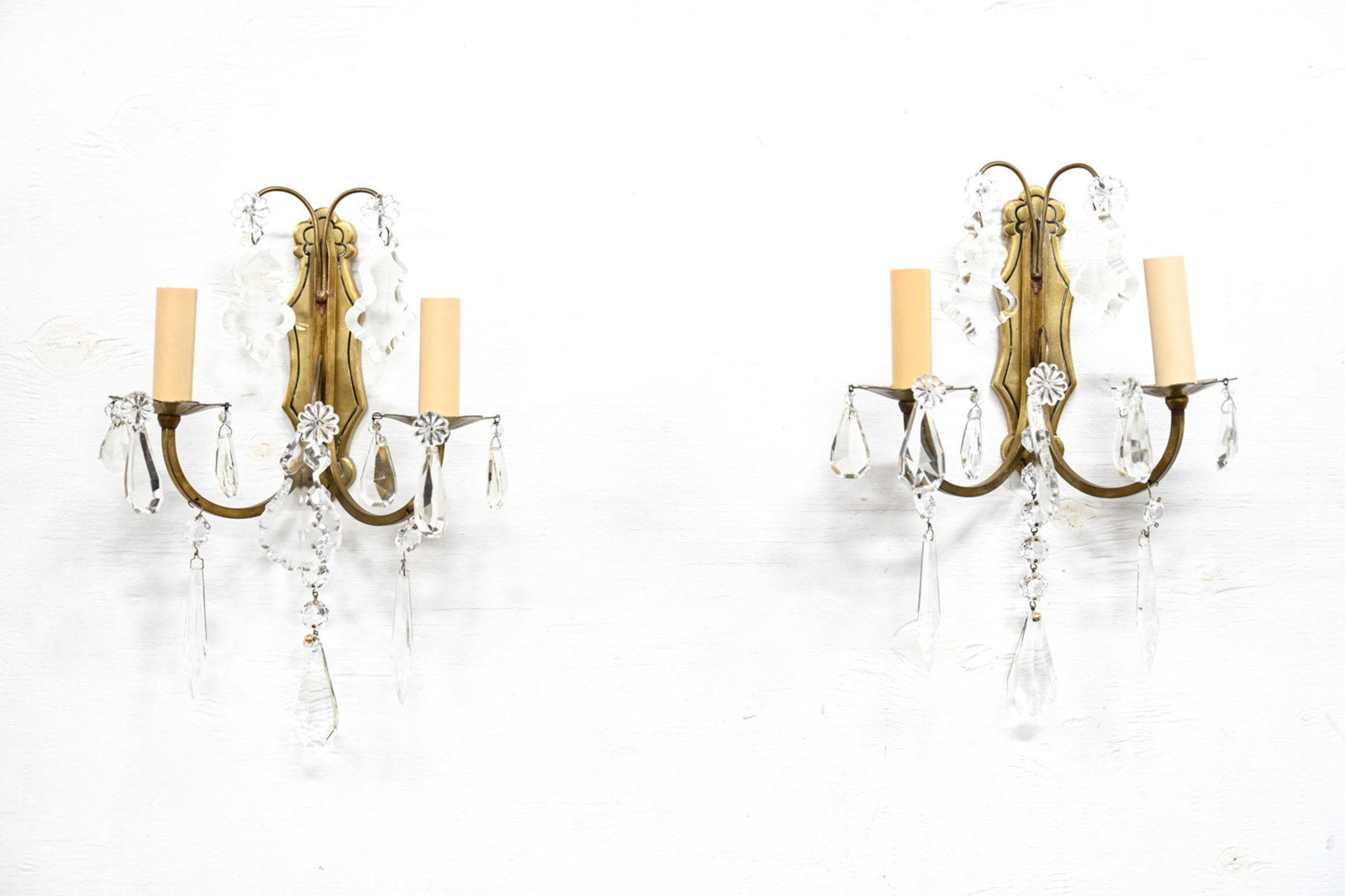 PAIR OF DROP CRYSTAL AND BRASS SCONCES: Dimensions: H 13" x W 8.75" x D 5"Condition: Wear consistent with age and use. Not tested.