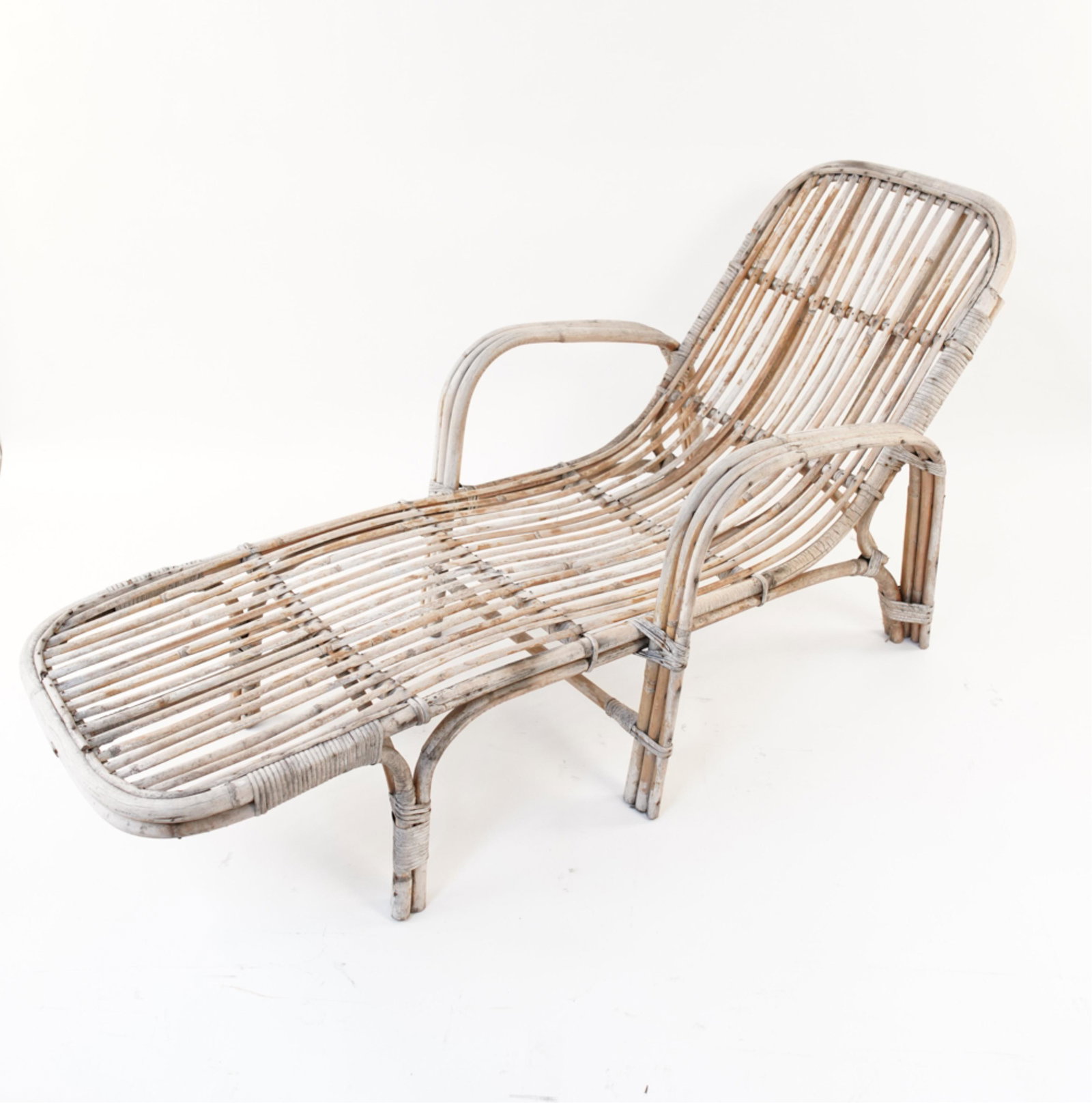 BAMBOO RATTAN CHAISE LOUNGE: Dimensions: H 32" x W 65" x D 25" S.H. 14" Condition: Showing signs of wear including chips and breaks to rattan strapping. Watermarks and stains due to outdoor exposure.