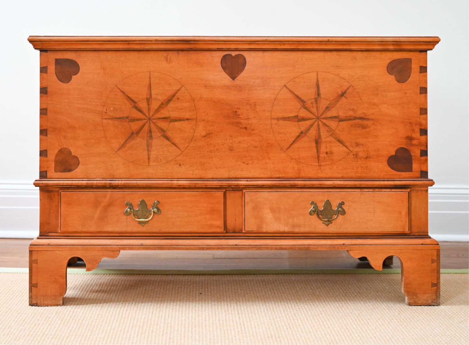 ELDRED WHEELER NANTUCKET BLANKET CHEST: Maple "Nantucket" chest by Eldred Wheeler with iron hinges, bracket base two drawers with brass pulls, and inlay work in compass rose and heart motifs. Eldred Wheeler label inside drawer. Dimensions: