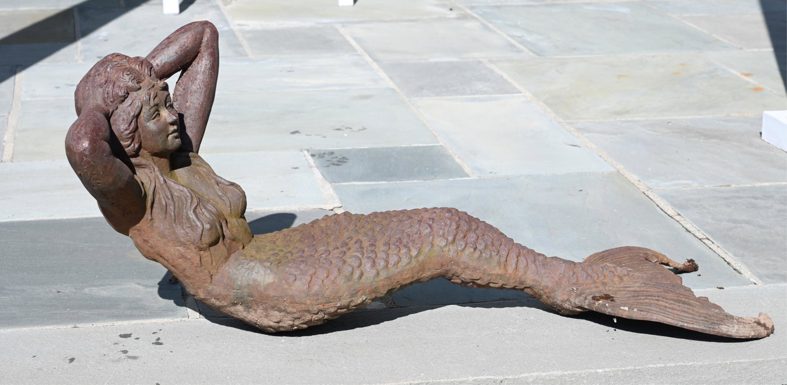 CAST IRON RECLINING MERMAID STATUE: Possibly salvaged from a ship. Dimensions: H 17" x W 40" x D 15" Condition: Wear and patina consistent with outdoor display. Ring on back apparently added later.