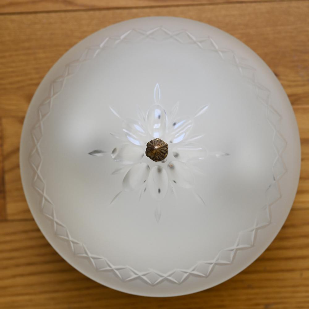 C. 1928 LIGHT FIXTURE W/ ETCHED GLASS SHADE: Art Deco-style flush mount light fixture with acorn finial and frosted and etched cut glass shade. Fixture replaced with contemporary Restoration Hardware fixture.Dimensions: H 6" x D 10" Condition: N
