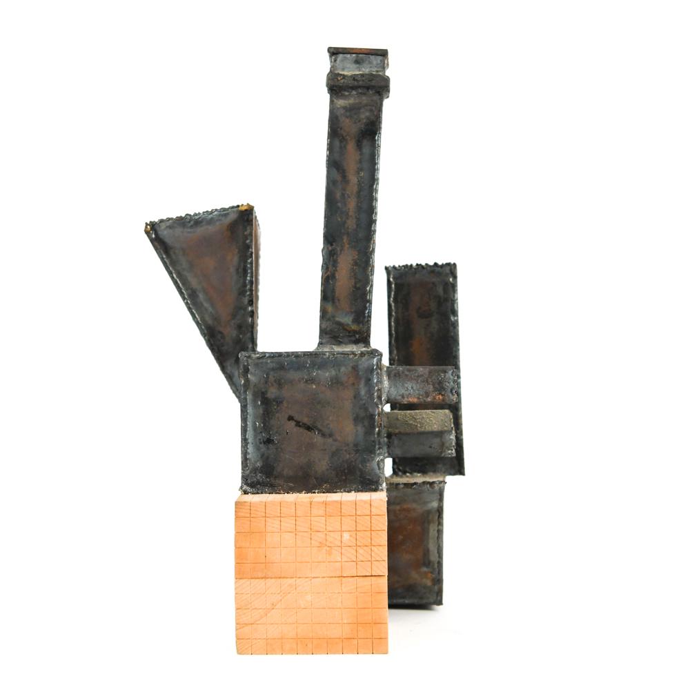 ABSTRACT ARCHITECTURAL IRON SCULPTURE: Apparently unsigned; abstract industrial torch-cut and welded iron on wood block. Dimensions: H 16" x W 9.5" x D 9" Condition: Minor scratches and scuffs consistent with age and display.